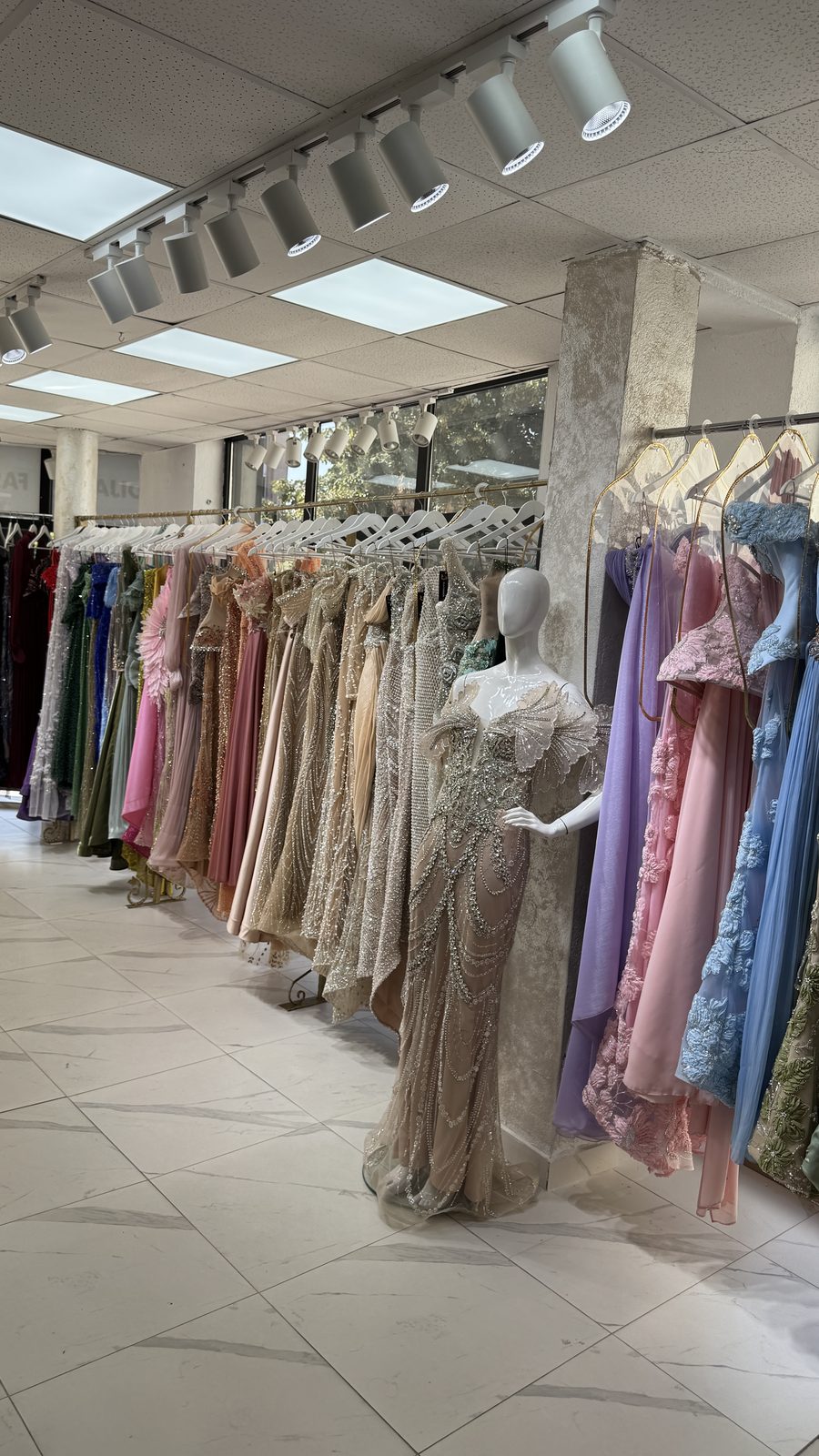 Evening gowns along the Dija Fashion showroom aisle
